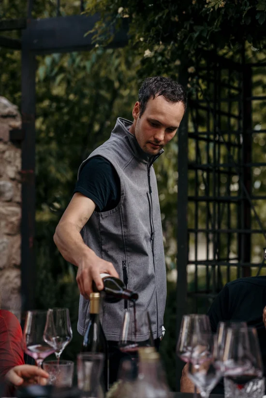 Weinservice im Ansitz Romani: Gastgeber schenkt Wein ein – Hotel in Tramin, Südtirol
